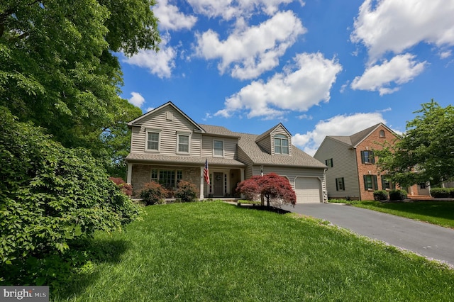 2969 Hearthside Ln, Lancaster, PA 17601 - traditional-style home featuring an attached garage, driveway, a front lawn, stone siding, and roof with shingles