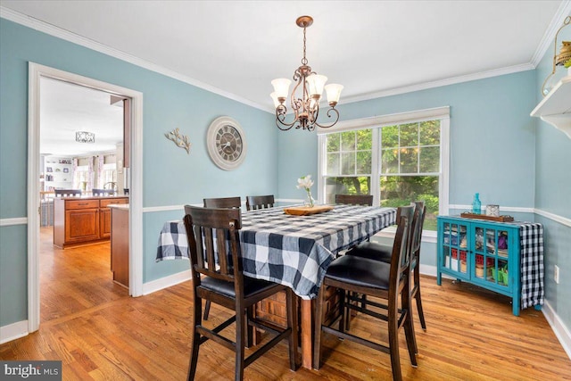 7501 Mason Ct, Middletown, MD 21769 - dining room with a chandelier, light wood finished floors, crown molding, and baseboards