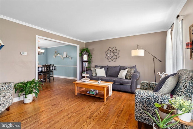 7501 Mason Ct, Middletown, MD 21769 - living room featuring a chandelier, wood finished floors, ornamental molding, and baseboards