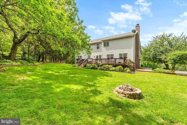 7501 Mason Ct, Middletown, MD 21769 - rear view of property with a fire pit, a deck, a chimney, and a lawn