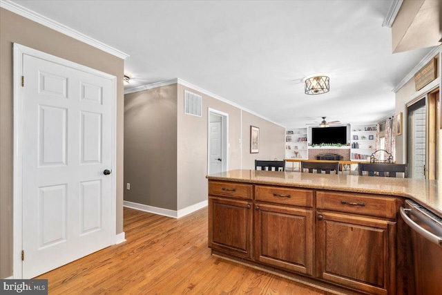 7501 Mason Ct, Middletown, MD 21769 - kitchen with dishwasher, a fireplace, light wood finished floors, crown molding, and baseboards