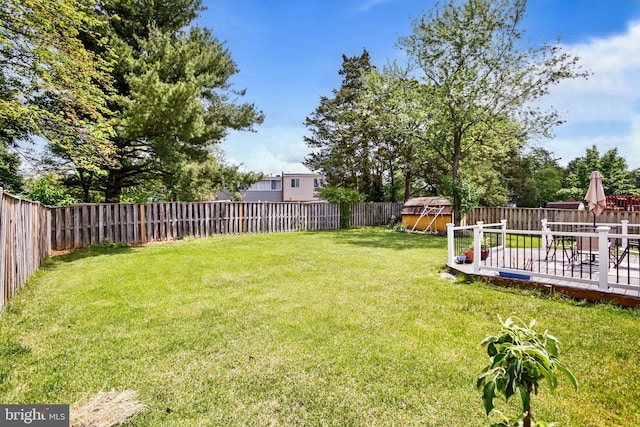 1218 Summerfield Dr, Herndon, VA 20170 - view of yard featuring a deck, a storage unit, and an outbuilding