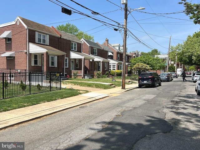 600 W 32nd St, Wilmington, DE 19802 - view of asphalt street featuring sidewalks, a residential view, street lights, and curbs
