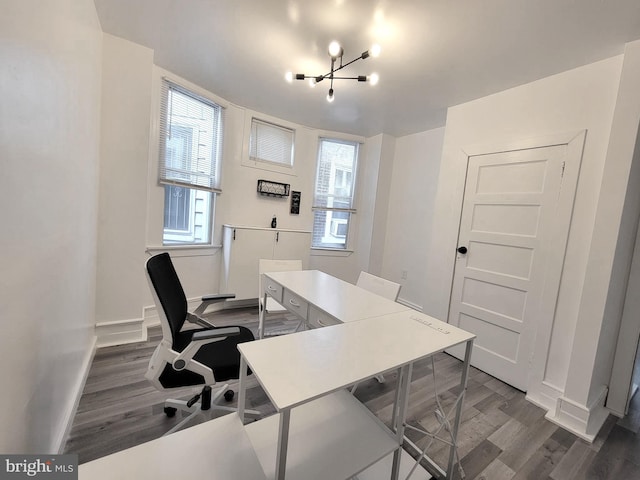 office featuring an inviting chandelier, baseboards, and dark wood-type flooring