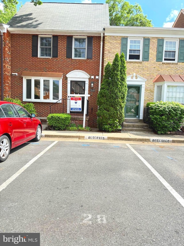 2649 Centennial Ct, Alexandria, VA 22311 - townhome / multi-family property featuring uncovered parking, brick siding, and entry steps