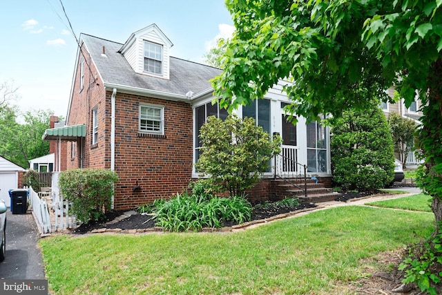 834 N Abingdon St, Arlington, VA 22203 - view of front of house with brick siding, a shingled roof, an outbuilding, and a garage