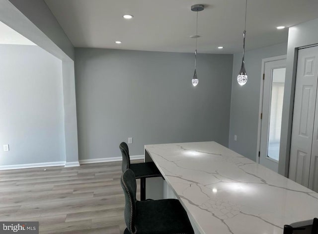 kitchen with pendant lighting, recessed lighting, baseboards, and light wood-style floors