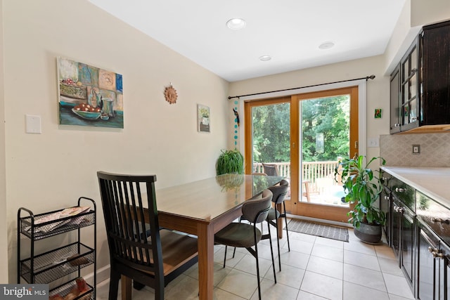 dining area featuring light tile patterned flooring and recessed lighting