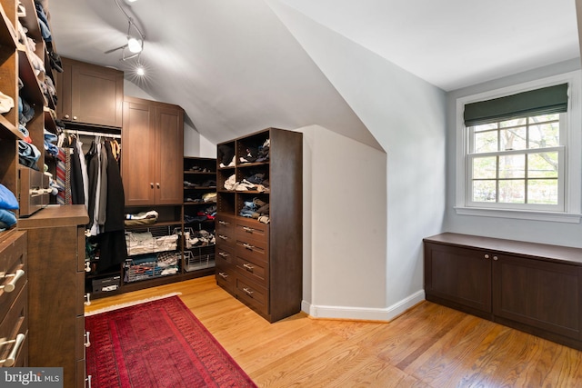 spacious closet with light wood finished floors and lofted ceiling