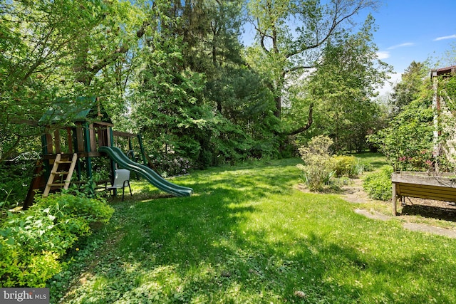 view of grassy yard with a playground