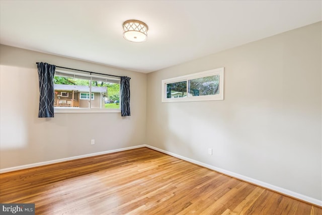 unfurnished room featuring wood finished floors and baseboards