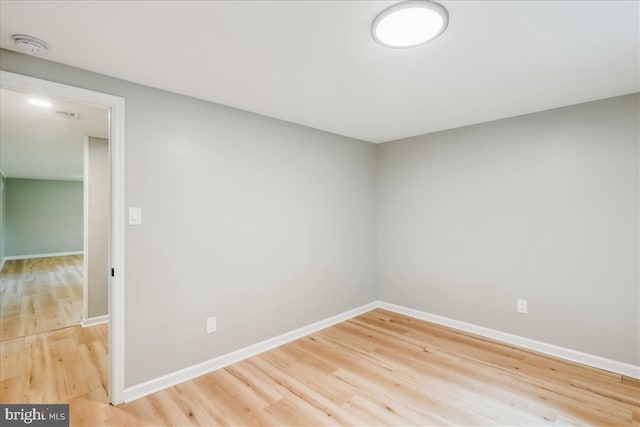 empty room with wood finished floors and baseboards