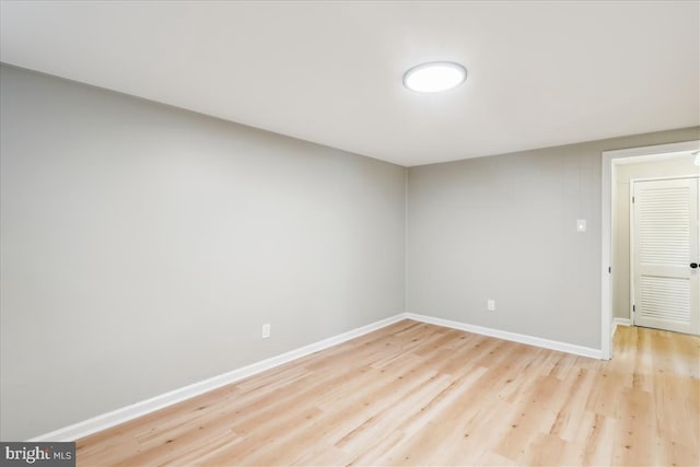 spare room with light wood finished floors and baseboards
