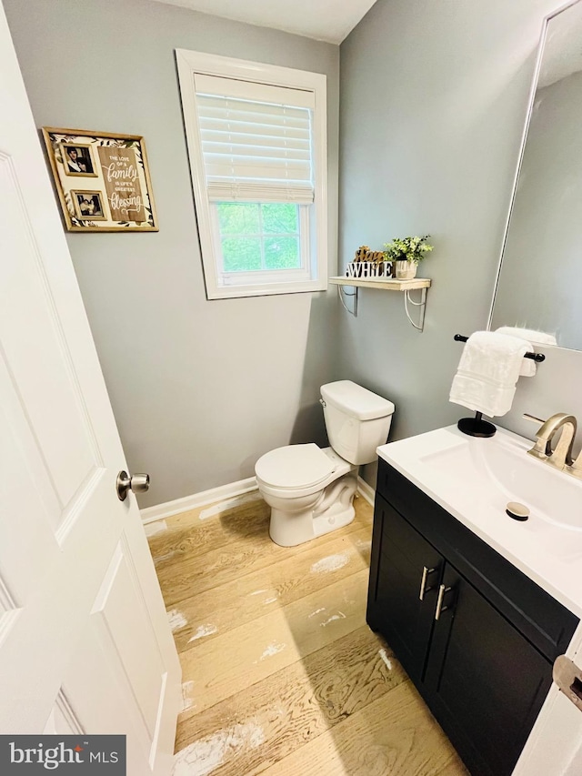 1241 Ridge Rd, Feasterville Trevose, PA 19053 - bathroom with vanity, toilet, baseboards, and wood finished floors