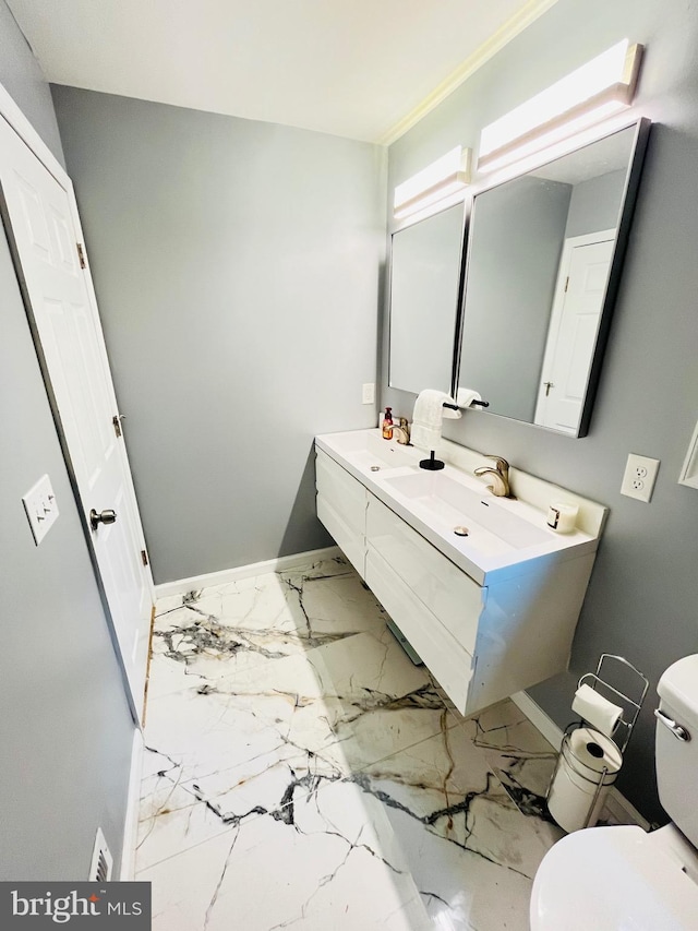 1241 Ridge Rd, Feasterville Trevose, PA 19053 - bathroom with double vanity, toilet, baseboards, and marble finish floor