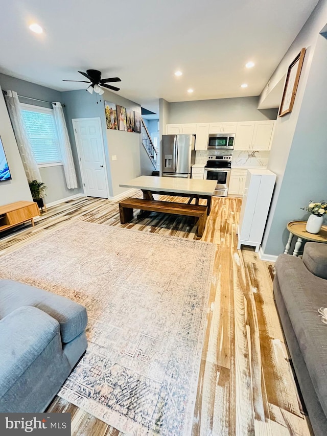 1241 Ridge Rd, Feasterville Trevose, PA 19053 - living room with stairway, baseboards, a ceiling fan, and light wood-style floors