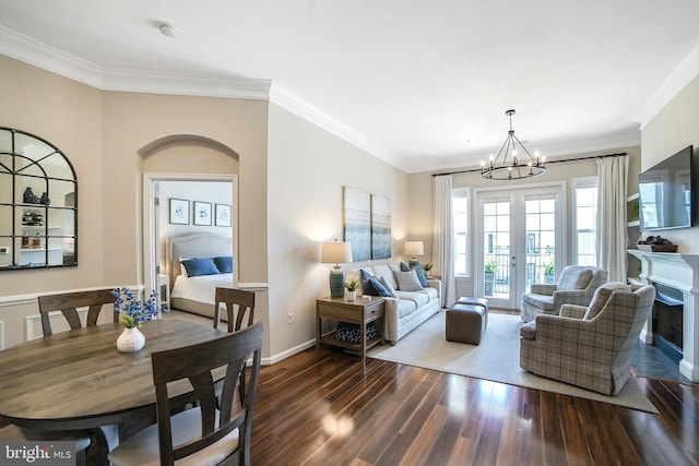 23 Arch Pl Unit 475, Gaithersburg, MD 20878 - living room featuring a chandelier, dark wood finished floors, crown molding, baseboards, and a fireplace