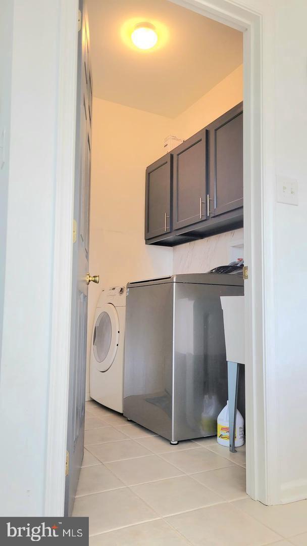 4 Elma Ave, Burlington, NJ 08016 - laundry area with cabinet space, light tile patterned floors, and washer and dryer