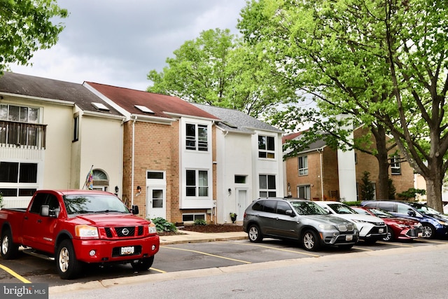 view of property featuring uncovered parking