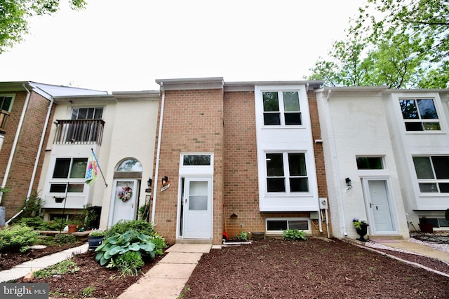 townhome / multi-family property with brick siding