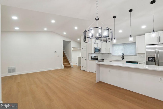 7813 Main Falls Cir, Baltimore, MD 21228 - kitchen with appliances with stainless steel finishes, a sink, light countertops, a chandelier, and white cabinetry