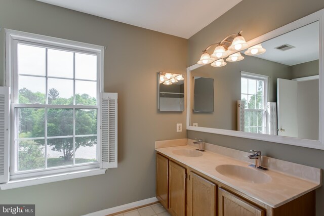 10703 Moray Ct, Cheltenham, MD 20623 - full bath with baseboards, double vanity, a chandelier, and tile patterned flooring