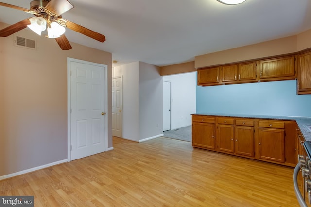 10703 Moray Ct, Cheltenham, MD 20623 - kitchen featuring brown cabinetry, light wood-type flooring, ceiling fan, and baseboards