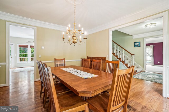 12630 Garry Glen Dr, Bristow, VA 20136 - dining room featuring wood finished floors, stairway, crown molding, a chandelier, and baseboards