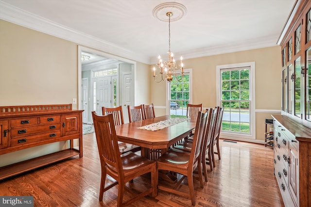 12630 Garry Glen Dr, Bristow, VA 20136 - dining room featuring a chandelier, ornamental molding, and light wood finished floors