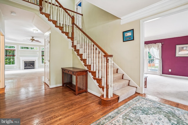 12630 Garry Glen Dr, Bristow, VA 20136 - staircase with a ceiling fan, baseboards, crown molding, wood finished floors, and a fireplace