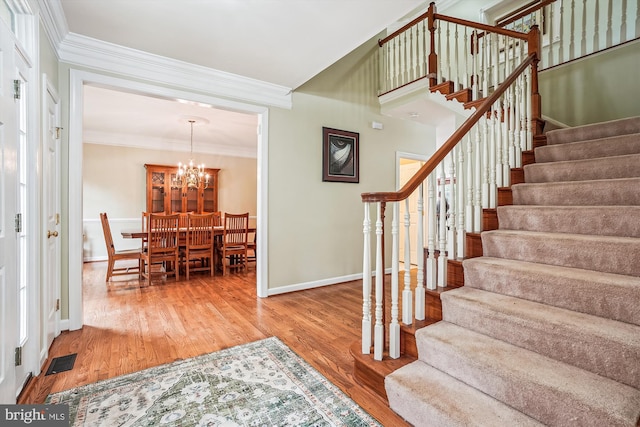 12630 Garry Glen Dr, Bristow, VA 20136 - stairs with wood finished floors, ornamental molding, baseboards, and a chandelier