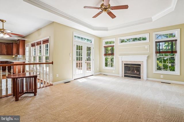 12630 Garry Glen Dr, Bristow, VA 20136 - unfurnished living room featuring ceiling fan, a raised ceiling, baseboards, crown molding, and light colored carpet