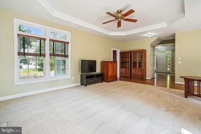 12630 Garry Glen Dr, Bristow, VA 20136 - unfurnished living room with a tray ceiling, carpet, ornamental molding, healthy amount of natural light, and baseboards