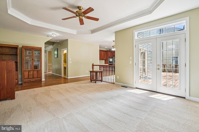 12630 Garry Glen Dr, Bristow, VA 20136 - unfurnished living room featuring a ceiling fan, a raised ceiling, carpet floors, french doors, and ornamental molding