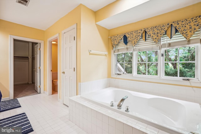12630 Garry Glen Dr, Bristow, VA 20136 - full bathroom with a garden tub, healthy amount of natural light, a closet, and tile patterned floors