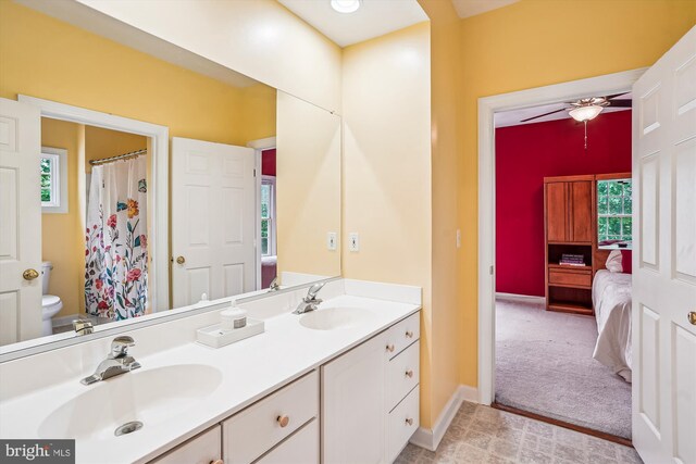 12630 Garry Glen Dr, Bristow, VA 20136 - bathroom with double vanity, ceiling fan, toilet, baseboards, and ensuite bathroom