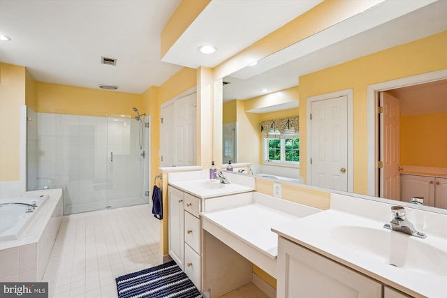 12630 Garry Glen Dr, Bristow, VA 20136 - bathroom featuring a stall shower, tile patterned floors, a bath, recessed lighting, and vanity