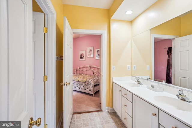 12630 Garry Glen Dr, Bristow, VA 20136 - bathroom with double vanity, baseboards, and ensuite bathroom