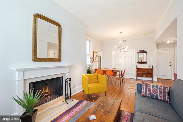 520 E Street Ne 105, Washington, DC 20002 - living room with hardwood / wood-style flooring, ornamental molding, baseboards, a notable chandelier, and a fireplace with flush hearth