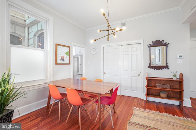 520 E Street Ne 105, Washington, DC 20002 - dining space featuring an inviting chandelier, wood finished floors, crown molding, visible vents, and baseboards