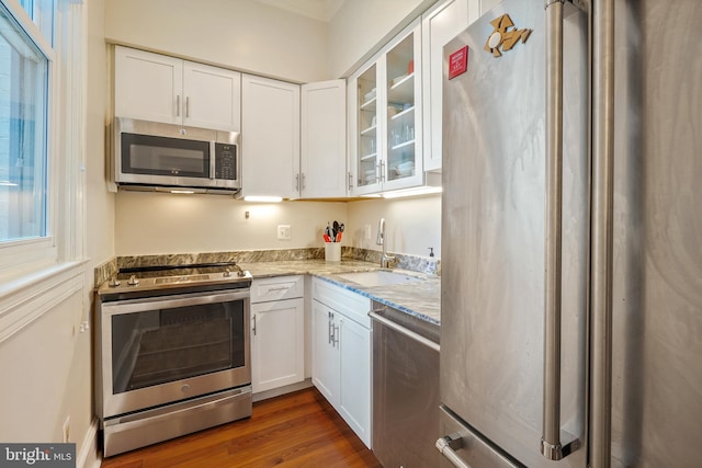 520 E Street Ne 105, Washington, DC 20002 - kitchen featuring white cabinets, glass insert cabinets, stainless steel appliances, and a sink