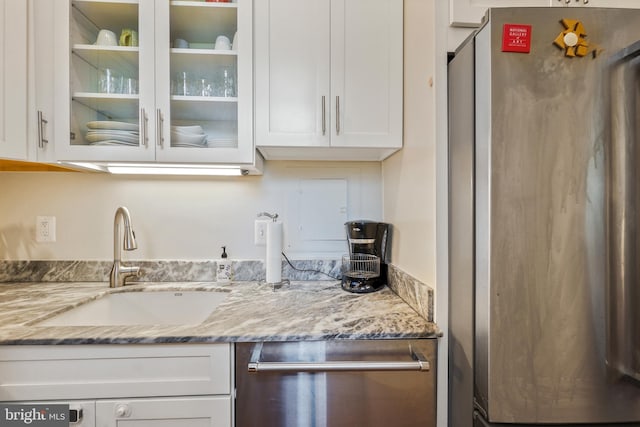 520 E Street Ne 105, Washington, DC 20002 - kitchen featuring white cabinets, appliances with stainless steel finishes, a sink, and glass insert cabinets