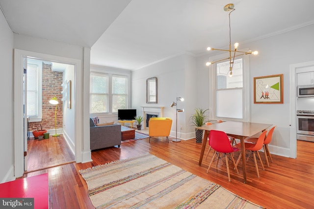 520 E Street Ne 105, Washington, DC 20002 - dining space with baseboards, hardwood / wood-style floors, an inviting chandelier, and ornamental molding