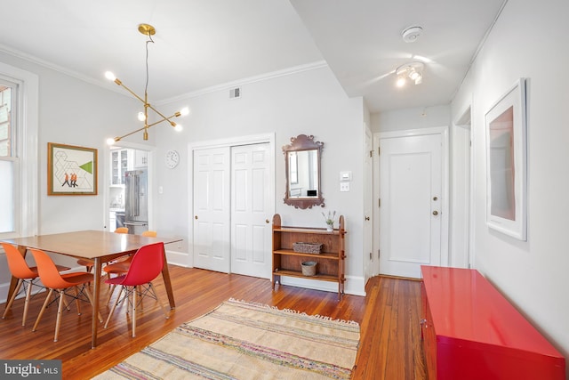 520 E Street Ne 105, Washington, DC 20002 - dining area featuring crown molding, hardwood / wood-style flooring, baseboards, and visible vents