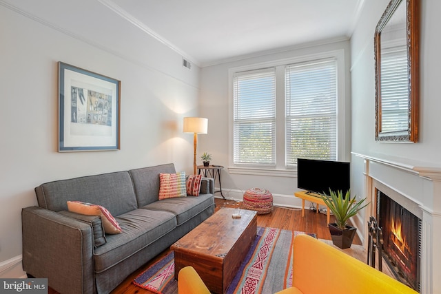 520 E Street Ne 105, Washington, DC 20002 - living area with a warm lit fireplace, wood finished floors, visible vents, crown molding, and baseboards