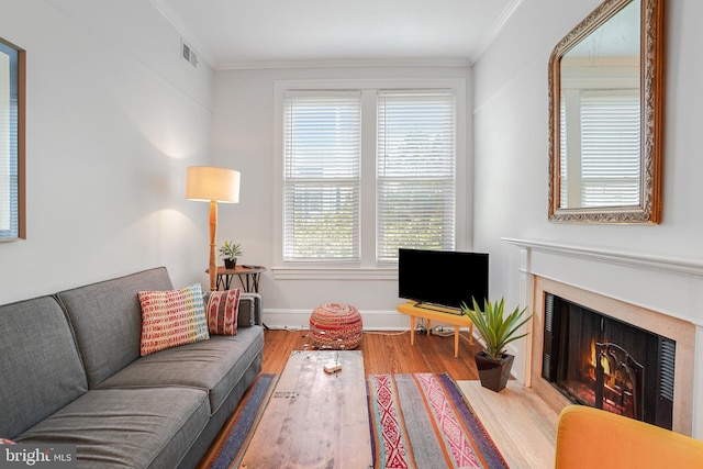 520 E Street Ne 105, Washington, DC 20002 - living area featuring baseboards, visible vents, a fireplace with flush hearth, crown molding, and wood finished floors