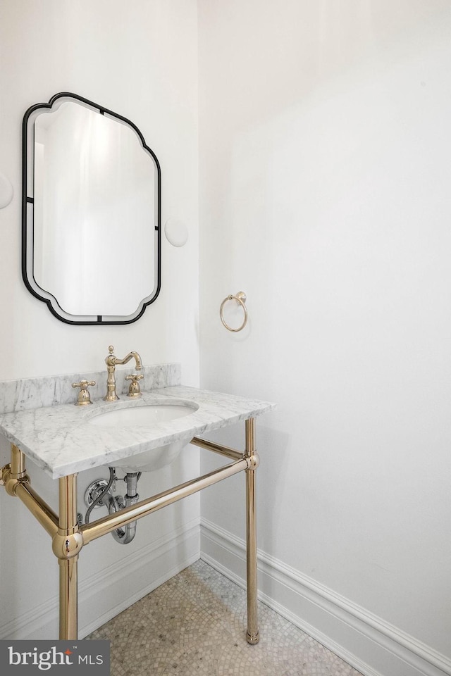 bathroom with baseboards and a sink