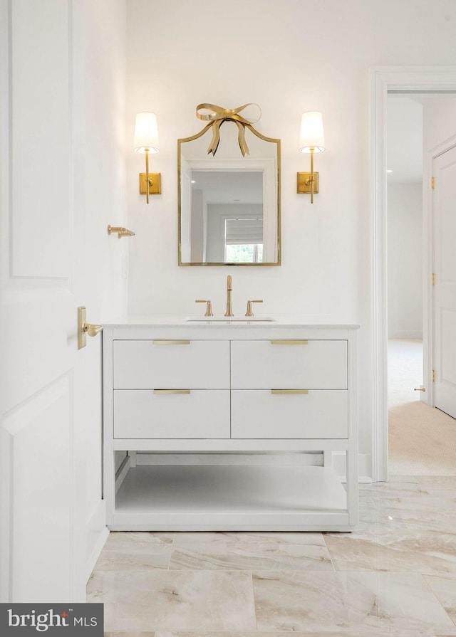 bathroom with vanity and marble finish floors