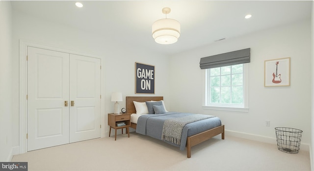 bedroom with light carpet, a closet, baseboards, and recessed lighting