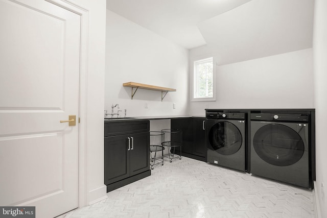 washroom with washer and dryer and cabinet space